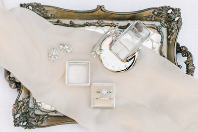 engagement ring and bridal jewelry on a tray
