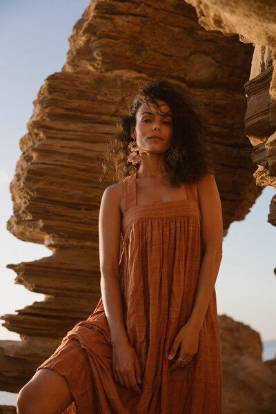 Woman and man are holding each other while looking in love during a love shoot during sunset on Ibiza