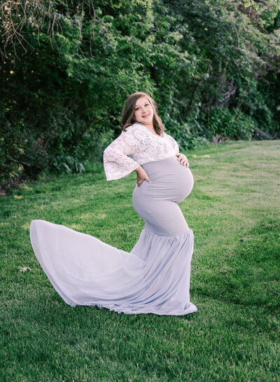 A flowy dress flies in the breeze in Utah maternity photos.