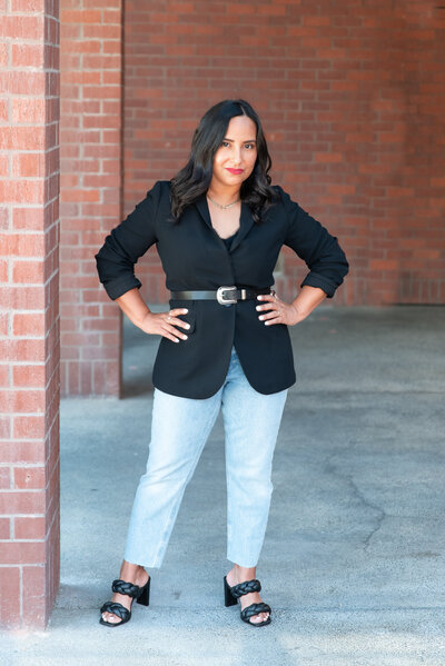 Fashion stylist standing with her hands on her hips posing during her personal branding photoshoot.