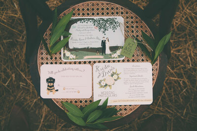 Romantic winery wedding invitation with hand-drawn illustrations of the bride and groom, fur baby, winery and floral details.