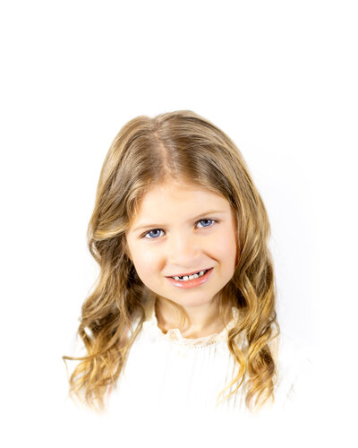 A classic heirloom children's portrait featuring a young toddler with golden hair and bright blue eyes, dressed in a traditional light blue outfit. Timeless children's photography with a soft, painterly background.