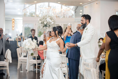 Joyful wedding celebration as the bride and groom toast with guests at their elegant reception.