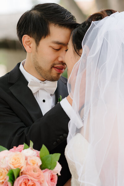 Groom resting his forehead on bride's forehead