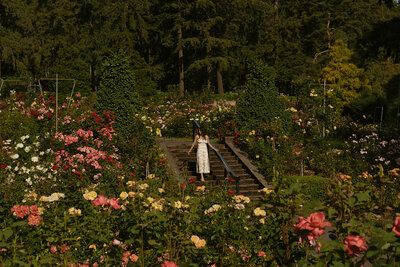 girl standing across Pittock Mansion in Portland, Oregon for senior photos