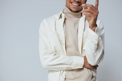 man in a turtleneck and jacket laughing