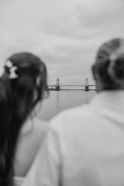 Portrait of D McHugh smiling with camera in hand, experienced wedding and portrait photographer in NC