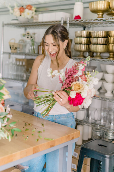 Rebel Rose owner Tracy wrapping silk ribbon on bridal bouquet