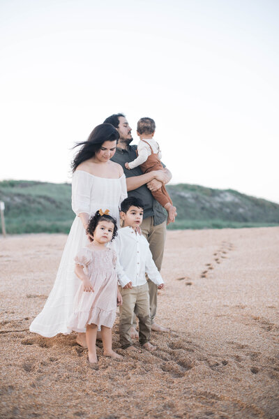 Family Portrait taken at Guana Beach near Jacksonville with the family of 5 looking out at the ocean