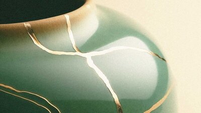 A stylish green vase with intricate gold lines, showcased in a therapist website design template.