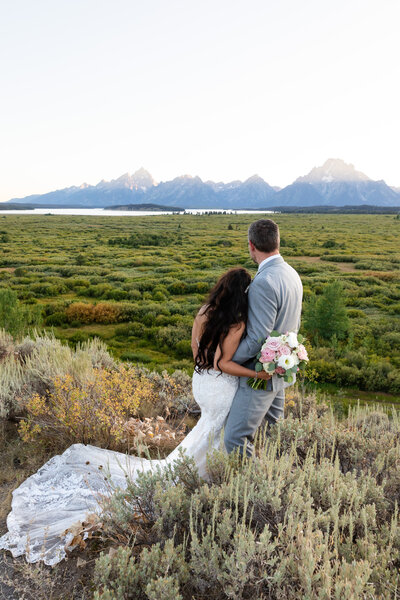 A bride and groom at sunset at their Jackson Lake Lodge Wedding in Grand Teton National Park.