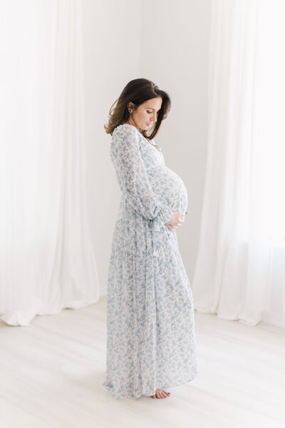 Bright and airy maternity photos in floral dress.