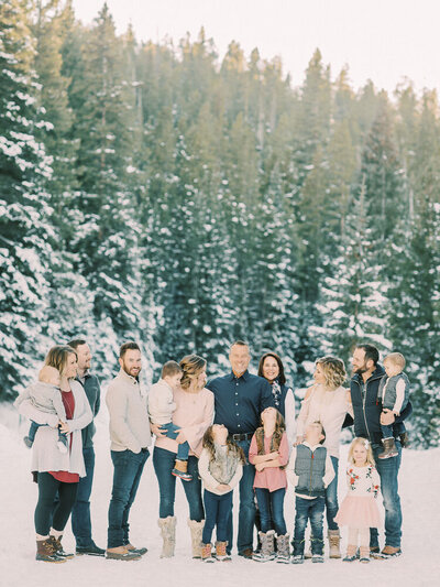 Extended family on ski vacation in Breckenridge, Colorado, color coordinating in pinks and blues