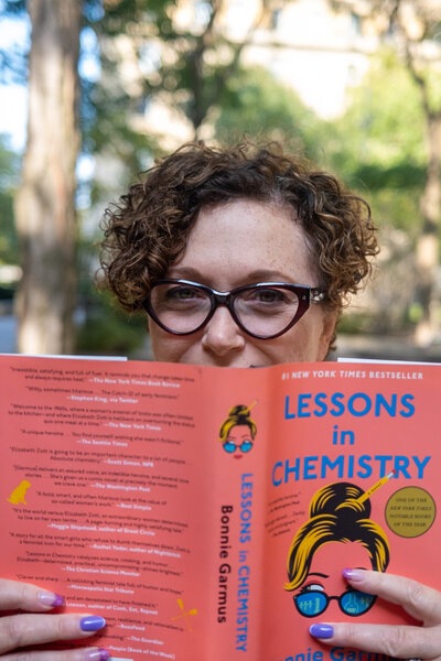 Tammy Aston reading 'Lessons in Chemistry,' reflecting on empowering women to overcome self-doubt through coaching.