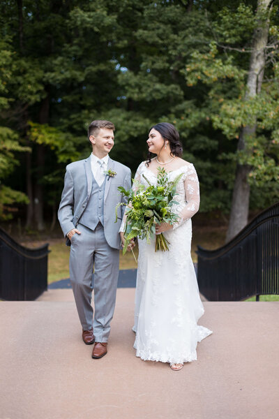 Bride and groom walking along hand in hand at Mahr Park Arboretum wedding, Kentucky