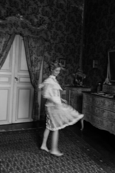 A person in a dress twirling and smiling 