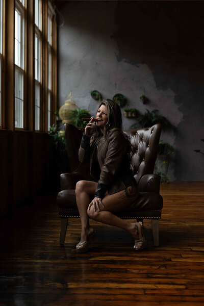 a sideview pose of a woman sitting on a chair