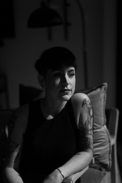 woman sits in chair