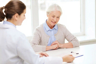 Doctor consulting elderly woman