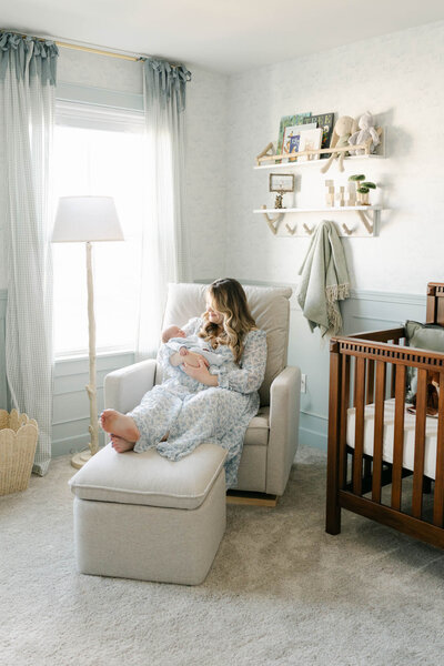pregnant mother in white Baltic Born dress holds toddler in white linen dress over her baby bump during a maternity photo session  in Delaware with AnneMarie Hamant