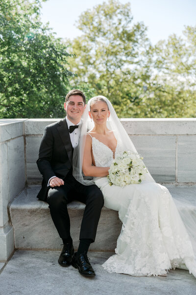 bride and groom sit on step