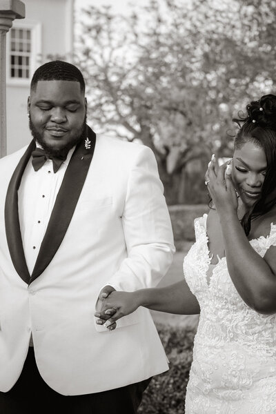 classy couple black tie wedding hold hands walk Tampa