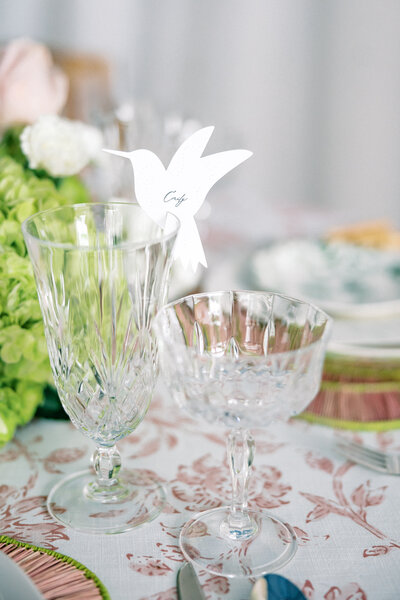 Paper hummingbird place cards with hand-drawn calligraphy names on crystal goblets and pink toile table linens for a spring wedding in Atlanta Georgia | Atlanta wedding photographer Emily Nicole Photography