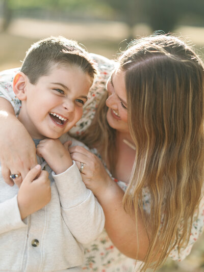 Closeup photo of Shalae and son Renner with Renner laughing and Shalae looking at him