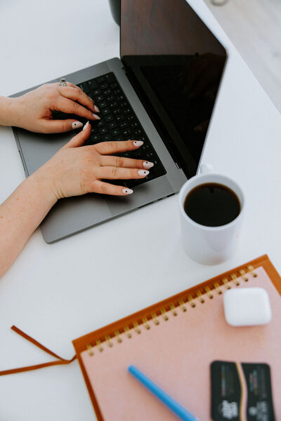 Copywriter Sara Gillis sitting at a desk with a computer