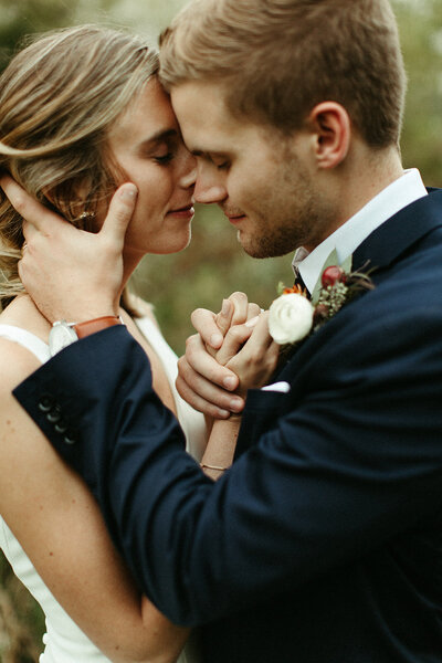 Couple sharing intimate embrace on their wedding day.