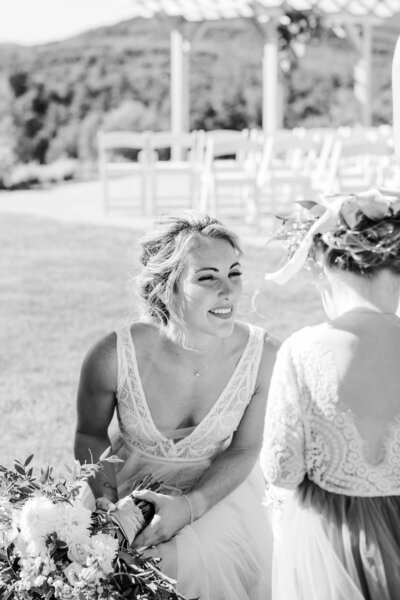 Black and white candid moment with bride and flower girl