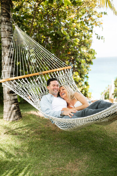 An engaged couple lays on a hammock the day before their wedding at Malliouhana in Anguilla