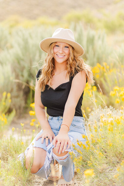 Girl posing for her high school senior photos in the sagebrush near Seminoe, Wyoming.