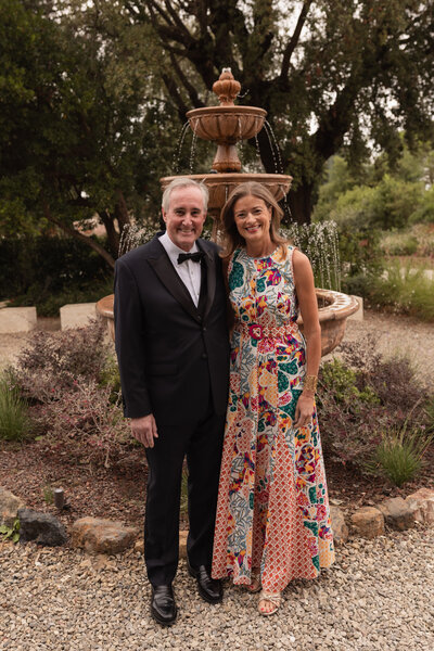 Wedding photographer captures couple taking a stroll hand in hand at their french chateau wedding.