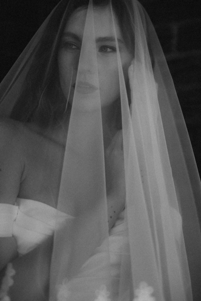 Black and white image of lady holding a camera, branding photoshoot on the Sunshine Coast