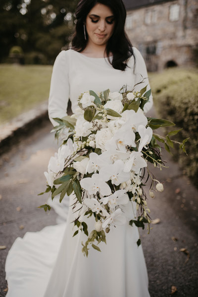 Stunning bride holds her all white bouquet at her Castle on Stagecoach, Little Rock Arkansas Wedding