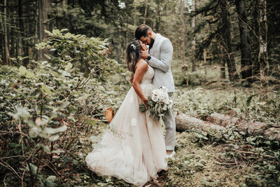 Bride and groom posing infront of a natural rocky backdrop