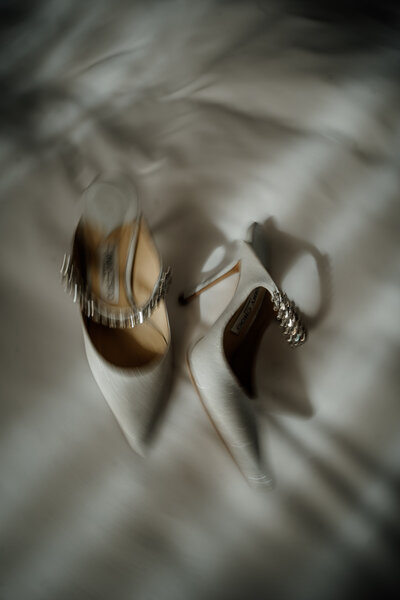 Bridal shoes on bed at Suffolk wedding