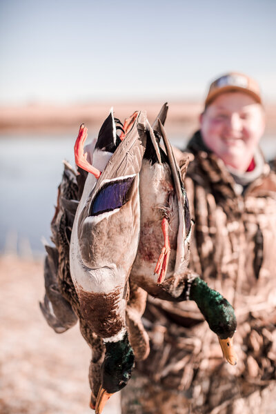 Young hunter showing off his Kansas ducks