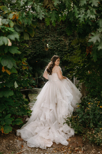 Bride in a moody garden setting.