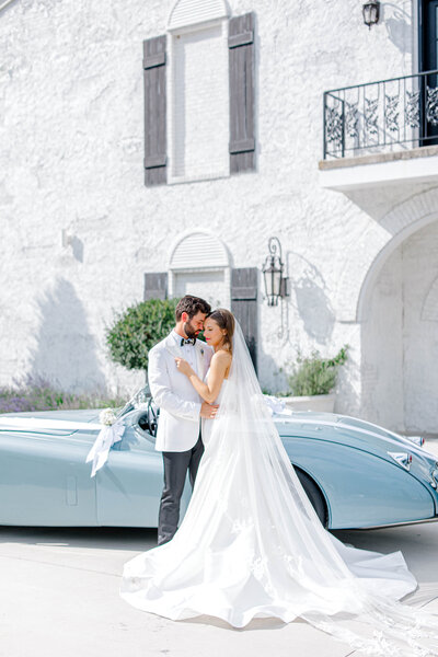 bride and groom kissing while she holds flowers