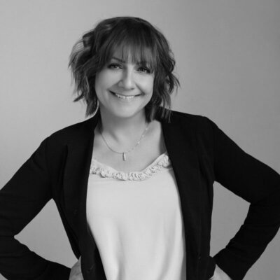 Woman with short hair and a cardigan Director of Business Development