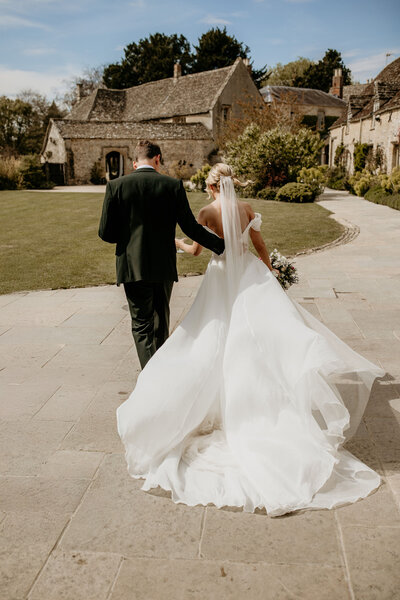 Bride and groom outside Caswell House during a sunny spring wedding in the gardens
