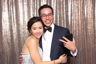 couple infront of a gold sequin photo booth backdrop