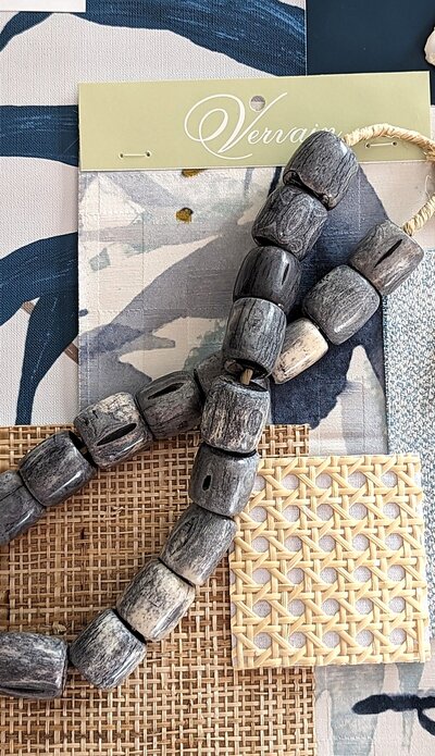 Coastal materials flat-lay -white oak, light stone, sea-glass tile, linen, and brushed metal for an airy coastal palette.