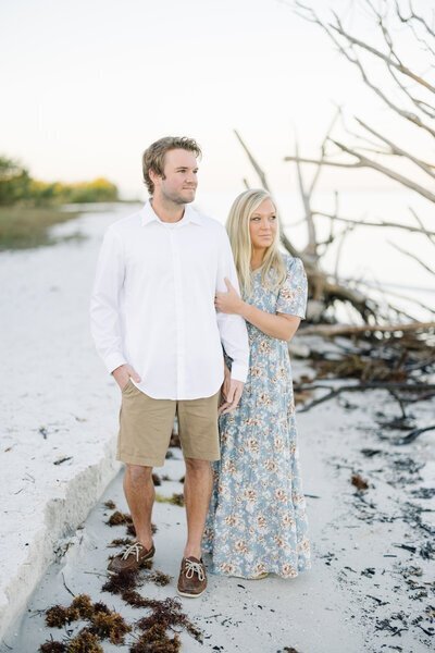Kacey Wyrick, one of the top photographers in minneapolis, standing on beach with husband