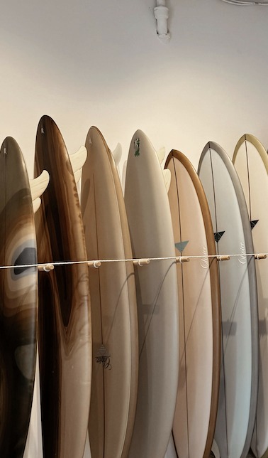 Surf boards lined up against wall