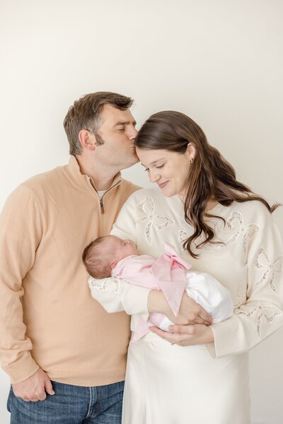 Family posing in nursery with new baby. - Newborn Photography Greenville SC
