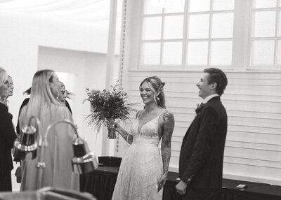 bride and groom laughing at guests