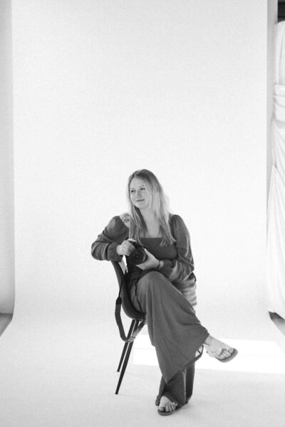 Moab elopement photographer sitting in a chair, camera in hand, ready to capture another couple's nature elopement in Utah.